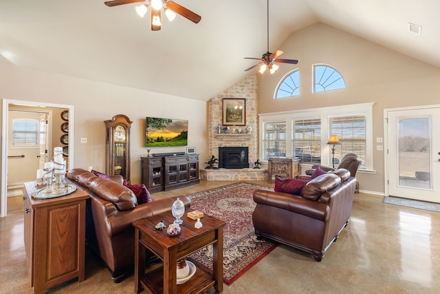 living room with a wood stove, ceiling fan, and high vaulted ceiling