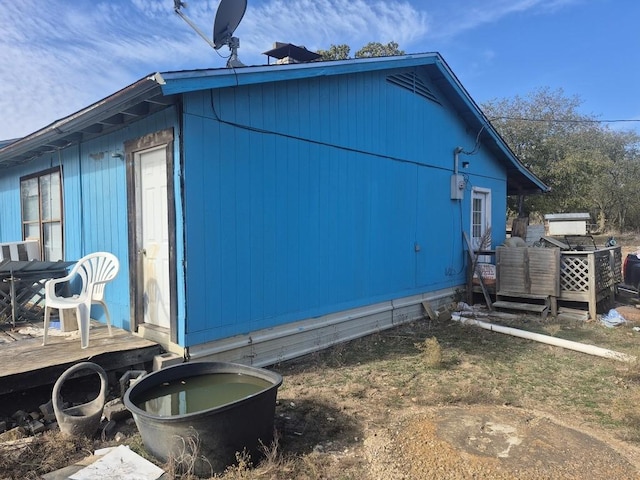 view of side of home featuring a deck