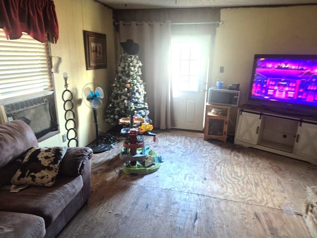 living room featuring wood-type flooring and wood walls