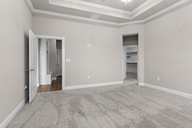 175 Quail Ridge Ct, Decatur, TX 76234 - unfurnished bedroom with carpet flooring, a raised ceiling, crown molding, baseboards, and a spacious closet