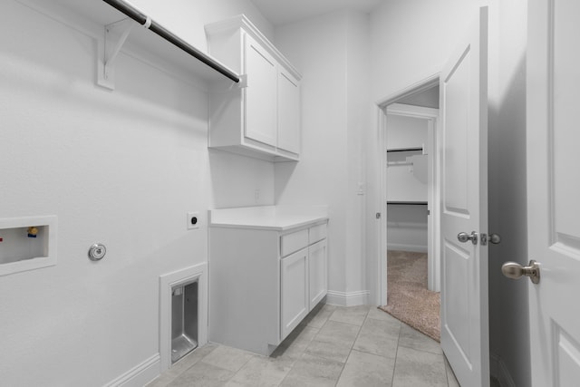 175 Quail Ridge Ct, Decatur, TX 76234 - laundry area featuring cabinet space, washer hookup, electric dryer hookup, light tile patterned flooring, and baseboards