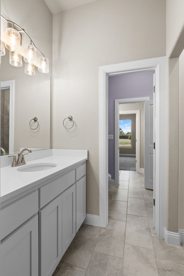 175 Quail Ridge Ct, Decatur, TX 76234 - bathroom featuring vanity, toilet, and baseboards