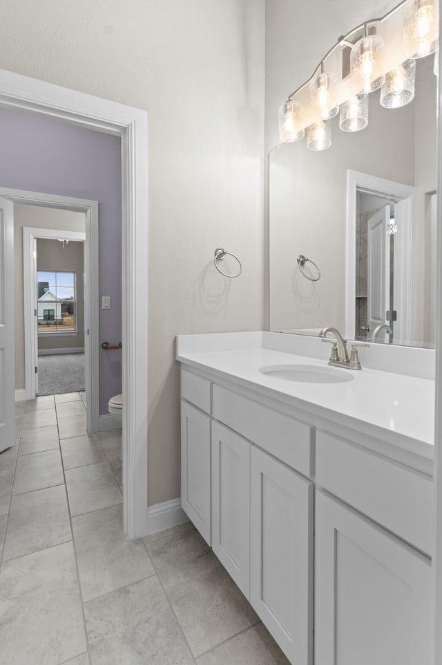 175 Quail Ridge Ct, Decatur, TX 76234 - bathroom with vanity, toilet, baseboards, and a chandelier