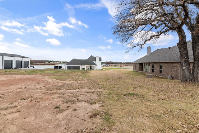 175 Quail Ridge Ct, Decatur, TX 76234 - view of yard featuring a detached garage, driveway, and an outbuilding