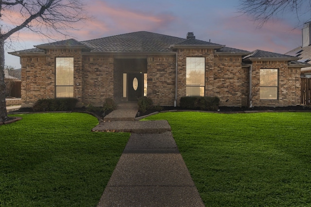 prairie-style home featuring a lawn