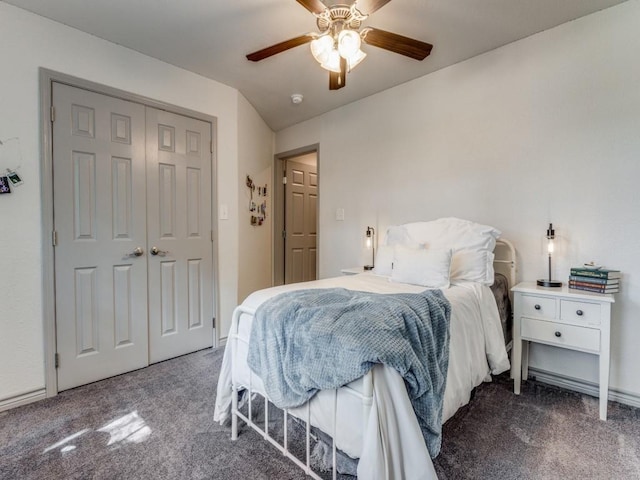 bedroom featuring ceiling fan, a closet, and dark colored carpet