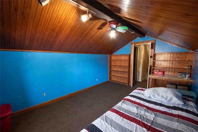 unfurnished bedroom featuring rail lighting, vaulted ceiling with beams, wood ceiling, dark colored carpet, and ceiling fan