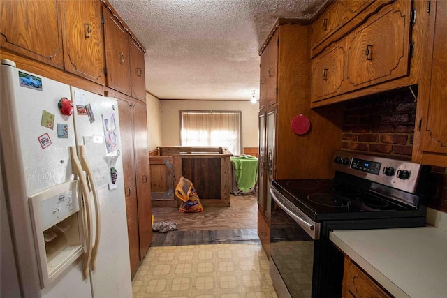 kitchen with white fridge with ice dispenser, a textured ceiling, and stainless steel range with electric stovetop