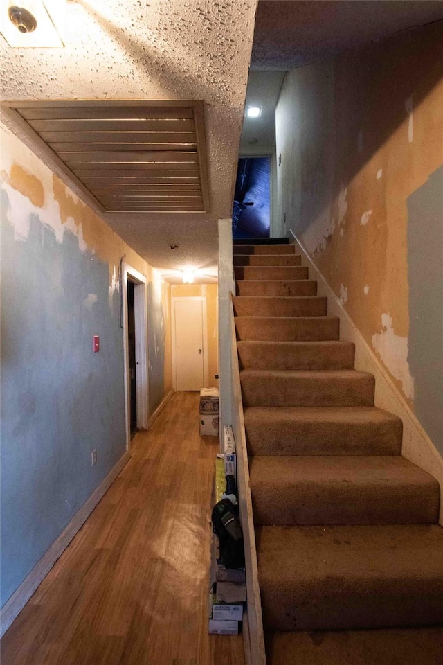 stairway with hardwood / wood-style floors