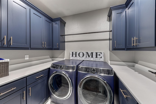 washroom featuring washer and dryer and cabinets