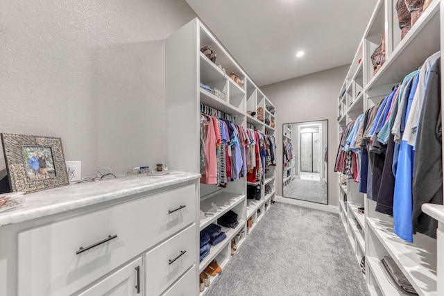 spacious closet featuring light carpet