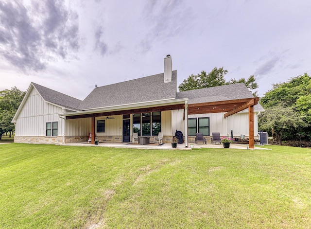 rear view of property featuring ceiling fan, a yard, central AC unit, and a patio