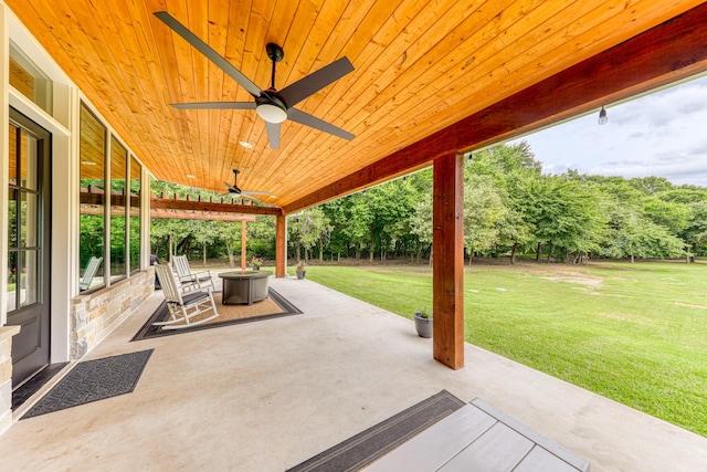 view of patio with ceiling fan and an outdoor fire pit