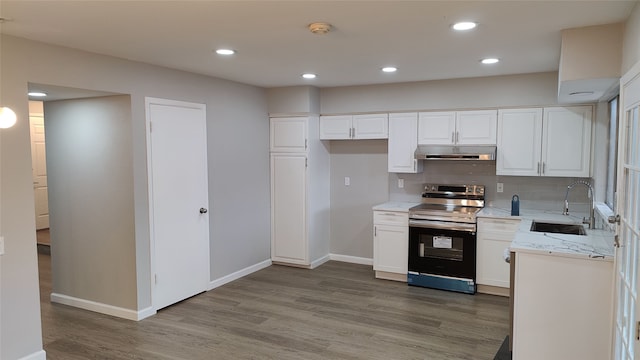 kitchen featuring sink, white cabinetry, and electric stove