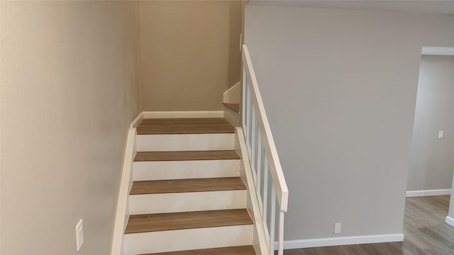 staircase featuring hardwood / wood-style flooring