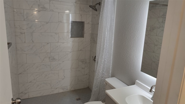 bathroom featuring vanity, curtained shower, and toilet