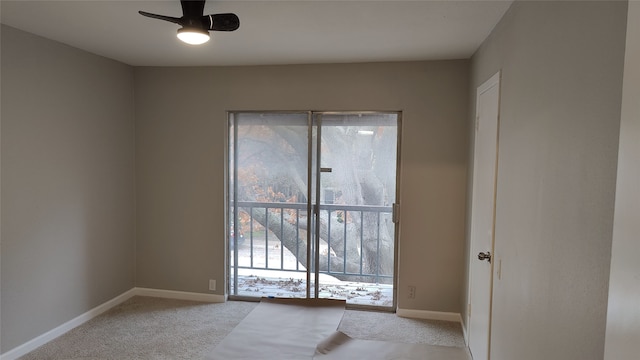 carpeted spare room with ceiling fan