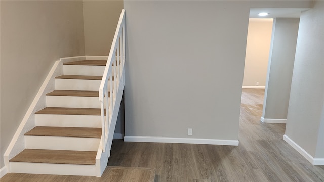 staircase featuring hardwood / wood-style flooring