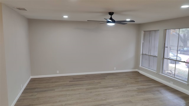 spare room with ceiling fan and light hardwood / wood-style flooring