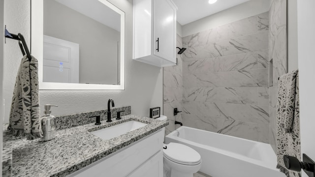 full bathroom with vanity, toilet, and tiled shower / bath