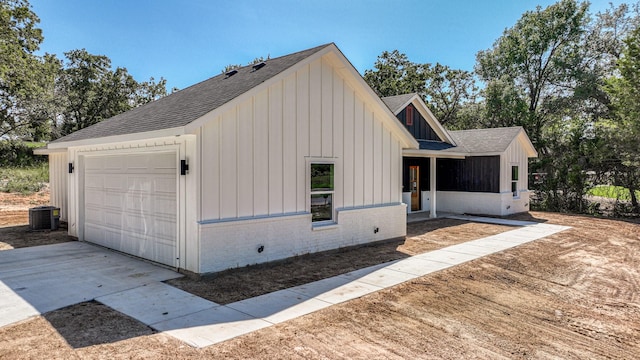 exterior space with a garage and central air condition unit