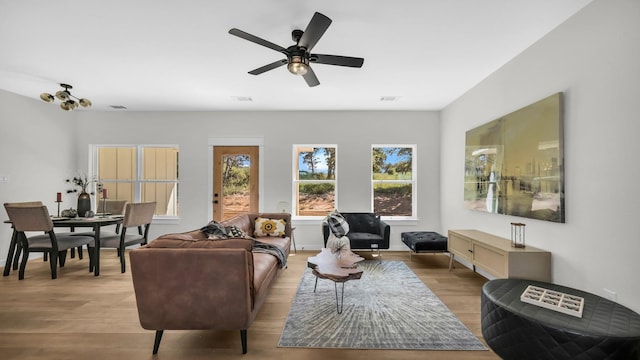 living room with light hardwood / wood-style floors and ceiling fan