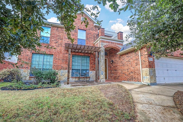 view of front of property featuring a garage, a balcony, and a front yard