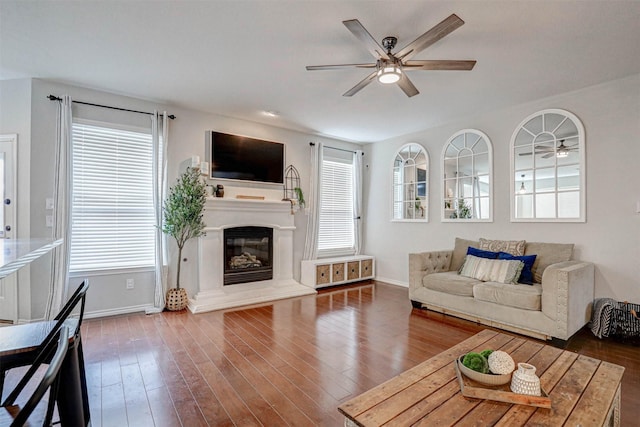 unfurnished living room with a wealth of natural light, hardwood / wood-style floors, and ceiling fan