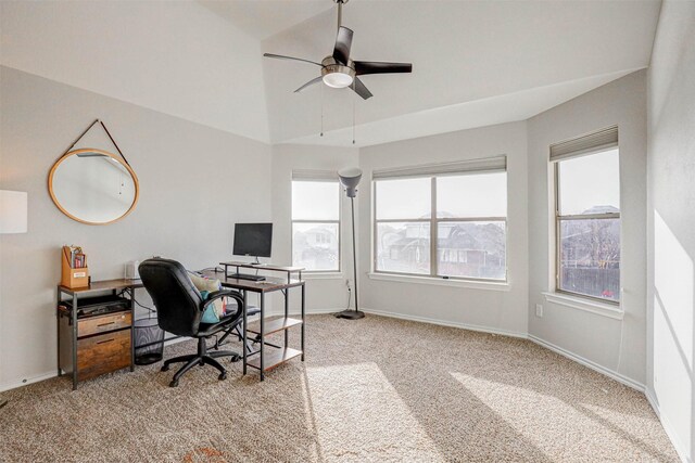 carpeted home office with ceiling fan and vaulted ceiling