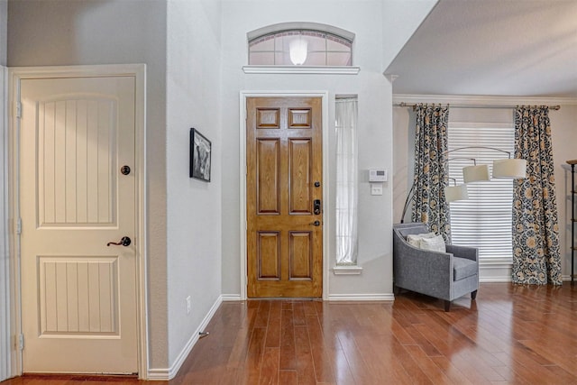 entryway with hardwood / wood-style floors and ornamental molding