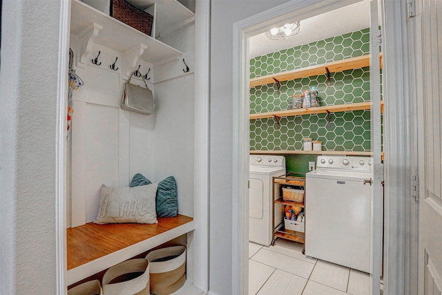 mudroom with washing machine and dryer and light tile patterned flooring