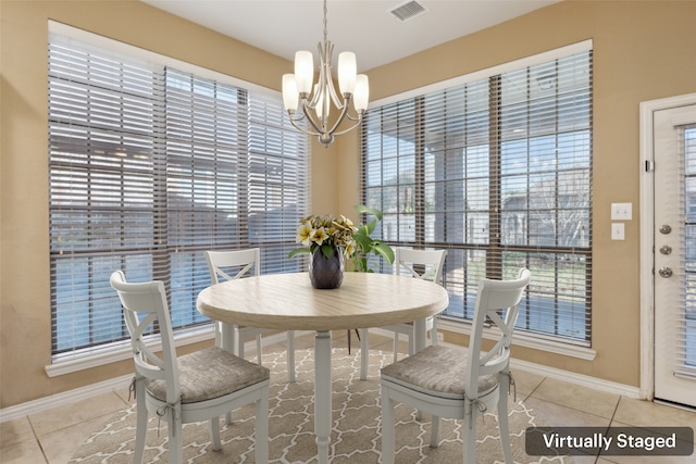 dining room with an inviting chandelier and light tile patterned floors