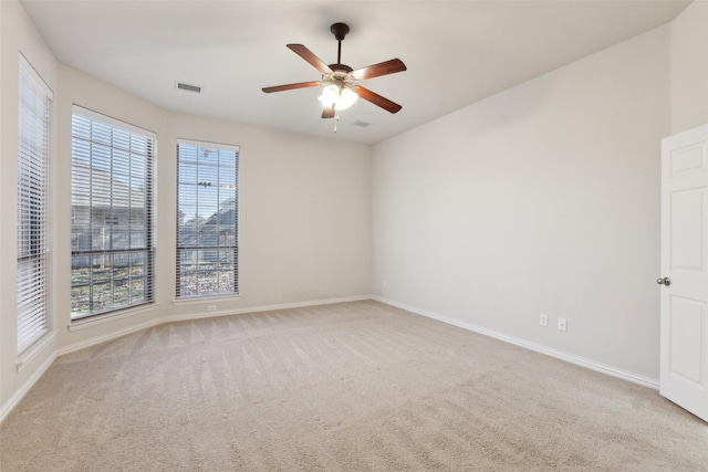 carpeted spare room featuring ceiling fan