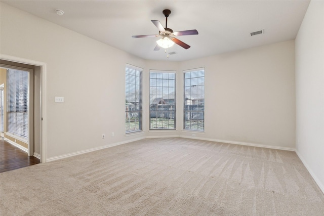 spare room with ceiling fan and carpet floors