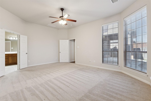 carpeted spare room featuring ceiling fan