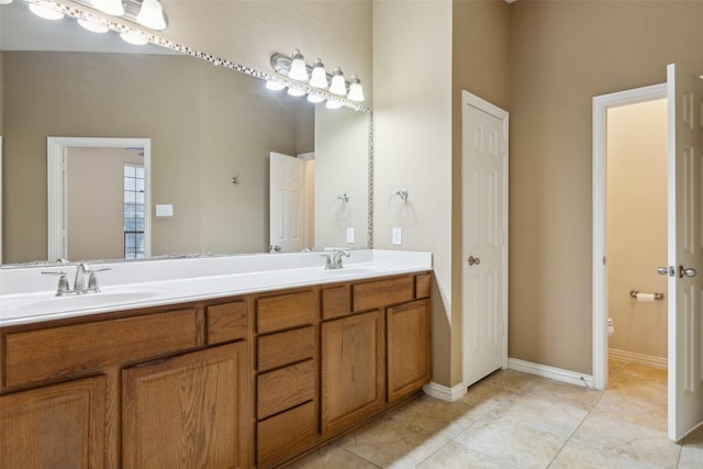 bathroom featuring vanity, tile patterned floors, and toilet