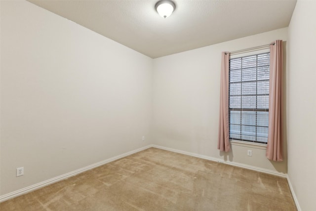 unfurnished room featuring light colored carpet