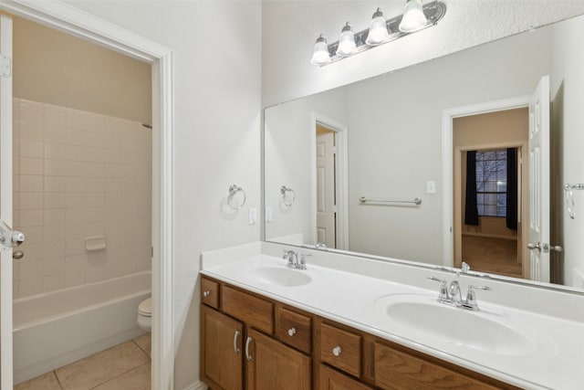 full bathroom with tiled shower / bath, vanity, toilet, and tile patterned flooring