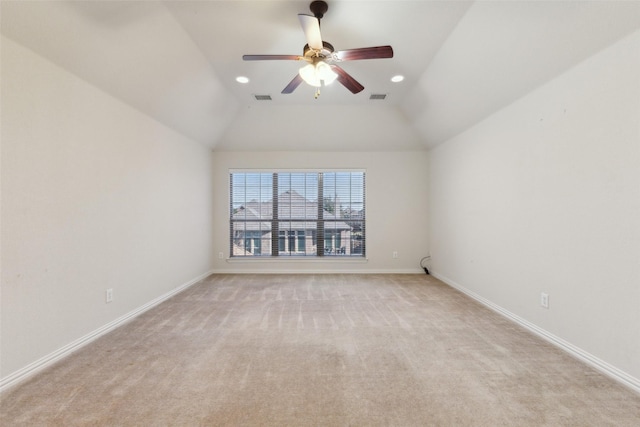 unfurnished room with vaulted ceiling, light colored carpet, and ceiling fan