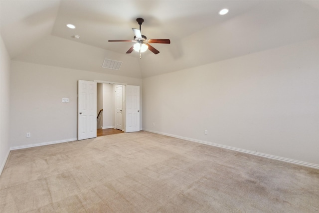 unfurnished bedroom with lofted ceiling, light carpet, and ceiling fan