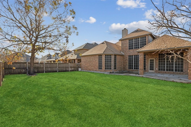 back of property featuring a patio and a lawn