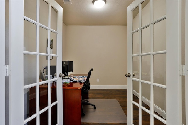 home office featuring dark hardwood / wood-style flooring and french doors