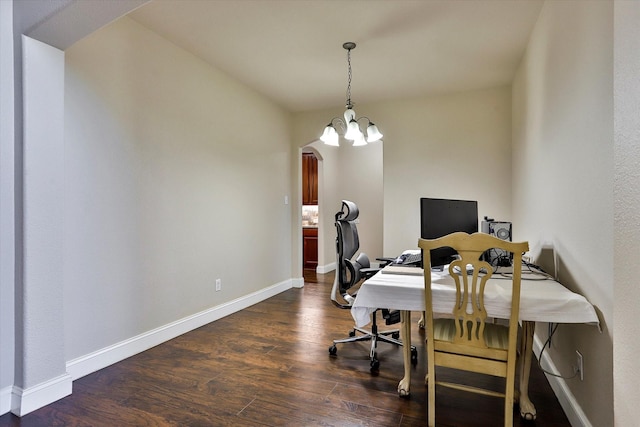 office area featuring a notable chandelier and dark hardwood / wood-style flooring