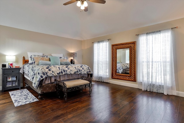 bedroom featuring multiple windows, dark hardwood / wood-style flooring, and ceiling fan