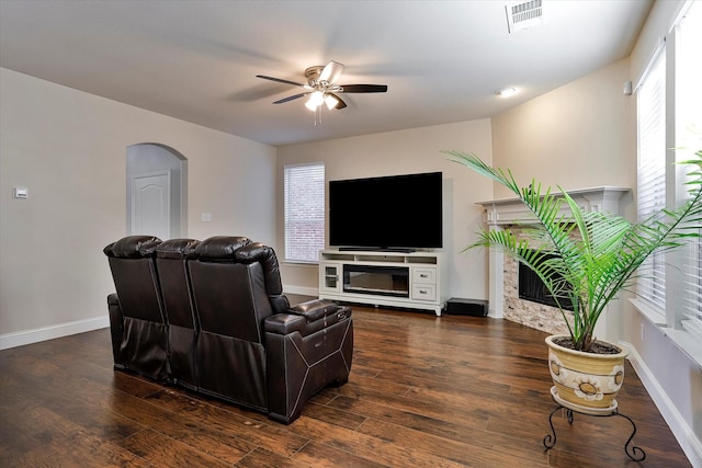 living room with ceiling fan and dark wood-type flooring