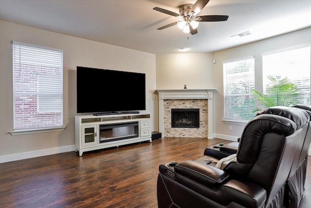 living room with a fireplace, dark hardwood / wood-style flooring, and ceiling fan