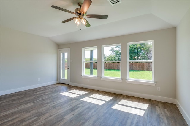 empty room with hardwood / wood-style flooring, vaulted ceiling, and ceiling fan