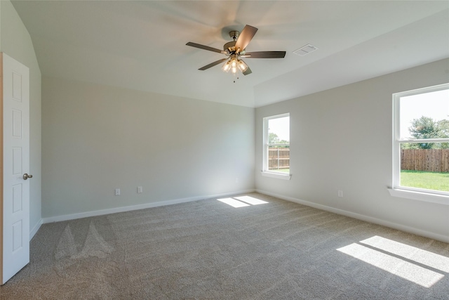 carpeted spare room featuring ceiling fan