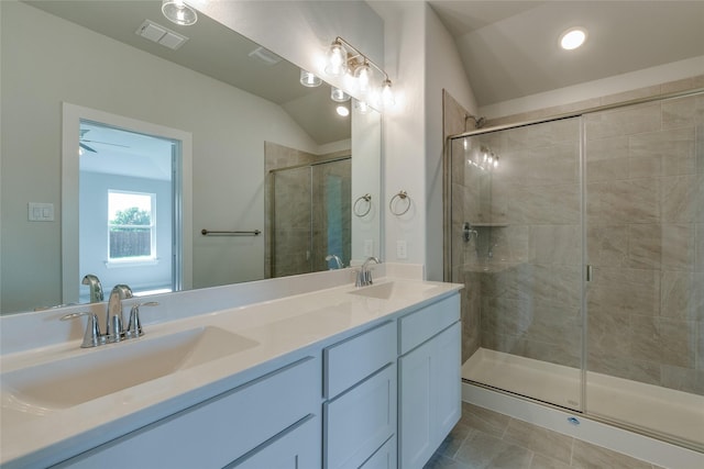 bathroom with vanity, ceiling fan, lofted ceiling, and walk in shower