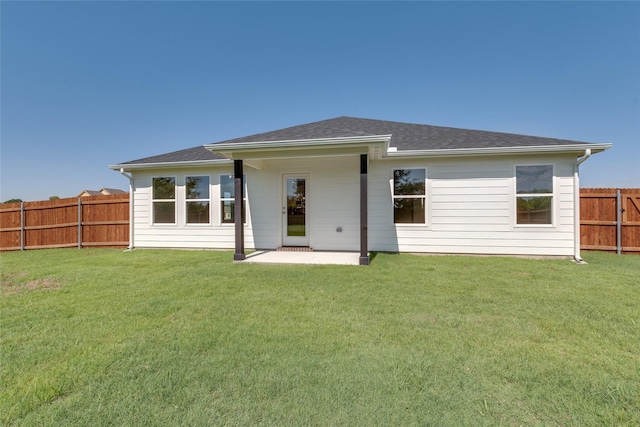 rear view of house featuring a lawn